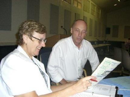 Photo Above:  (From Left) Professor Mary Francis & Fr. Scott viewing the Al-Hikmat Monthly Muslim Magazine.